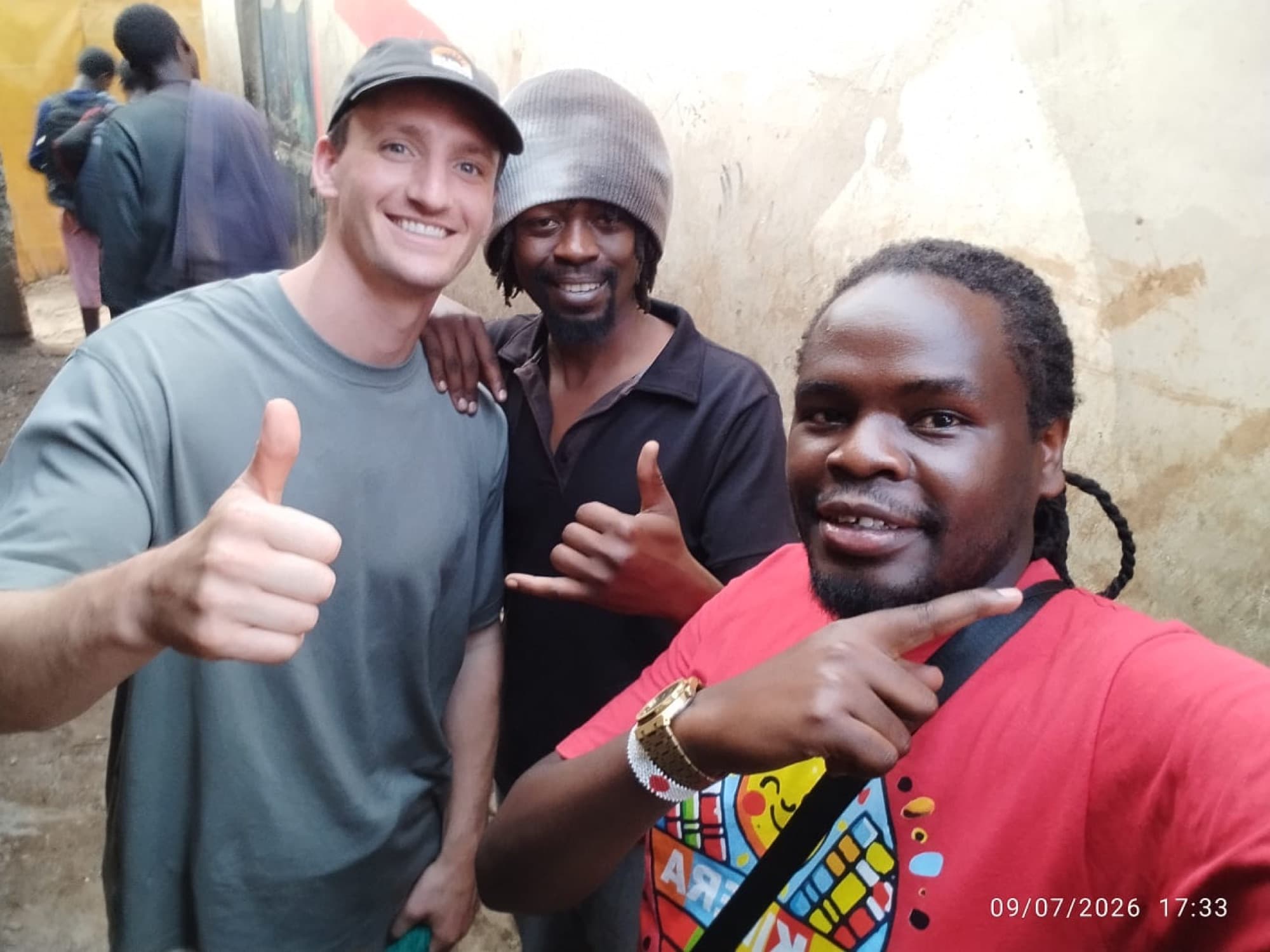 Sammy with a guest and a neighbour in Kibera
